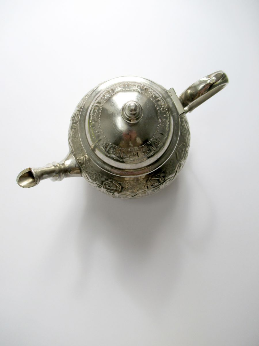 Photo of a silver teapot from above